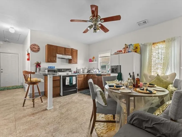 a kitchen with a dining table and chairs