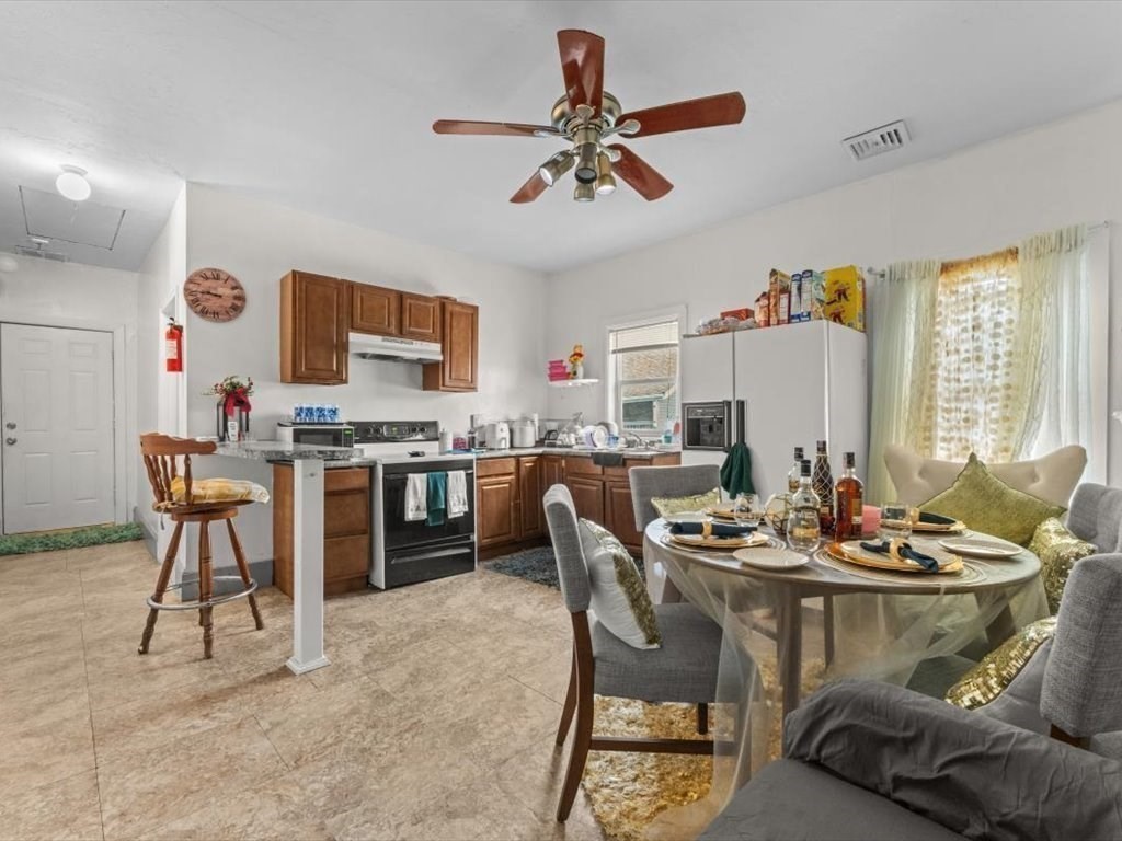 120 Grand Street Worcester, MA 01603 - Photo 15 of 36 a kitchen with a dining table and chairs