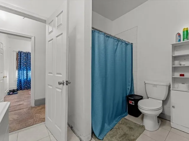 a white toilet sitting next to a bathroom sink