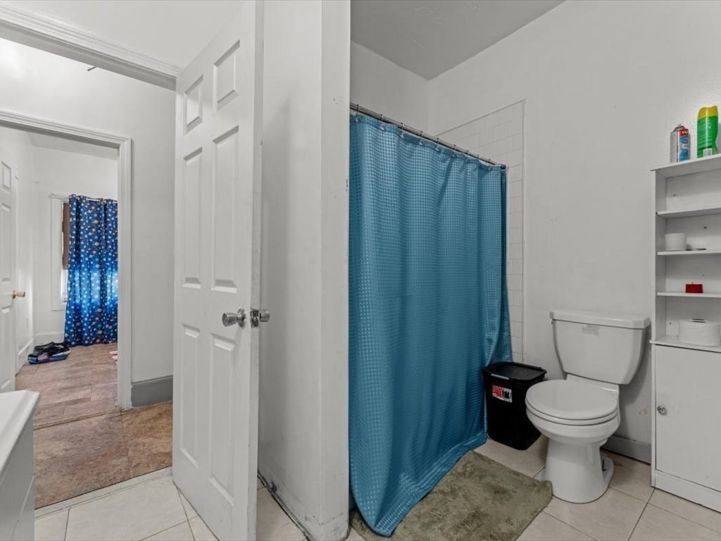 120 Grand Street Worcester, MA 01603 - Photo 18 of 36 a white toilet sitting next to a bathroom sink