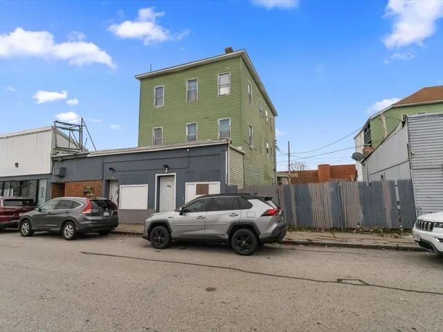 a view of cars parked in front of a house