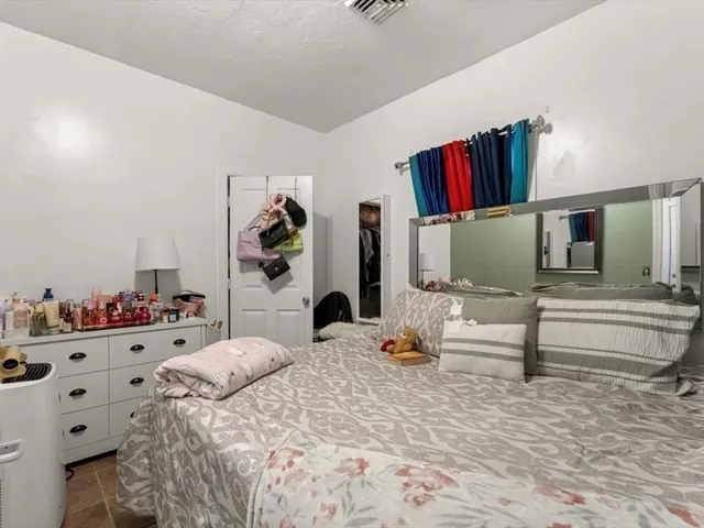 a bedroom with a bed and dresser