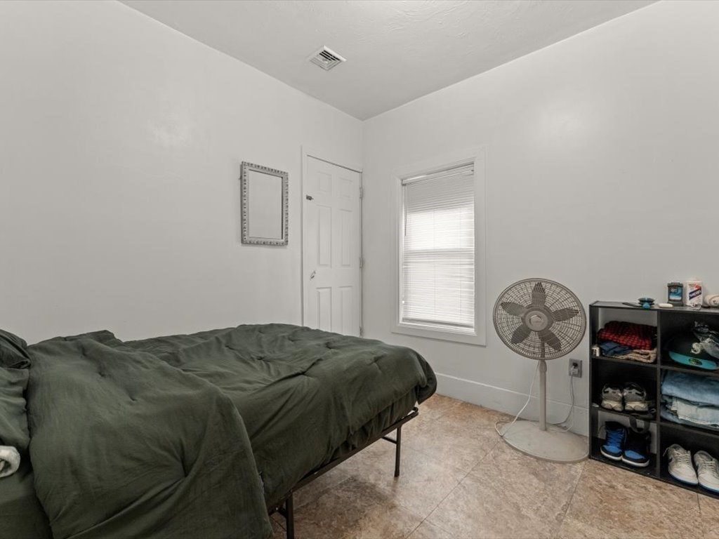 120 Grand Street Worcester, MA 01603 - Photo 23 of 36 a bed sitting in a room next to a window