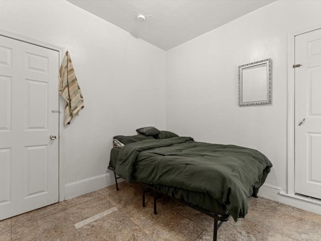 120 Grand Street Worcester, MA 01603 - Photo 24 of 36 a bedroom with a bed and a cabinets