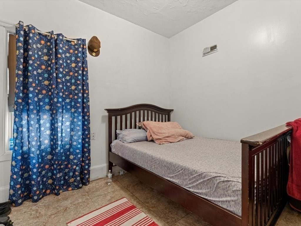 120 Grand Street Worcester, MA 01603 - Photo 26 of 36 a bedroom with a bed and a window