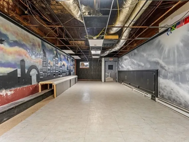 a view of an empty room with wooden walls