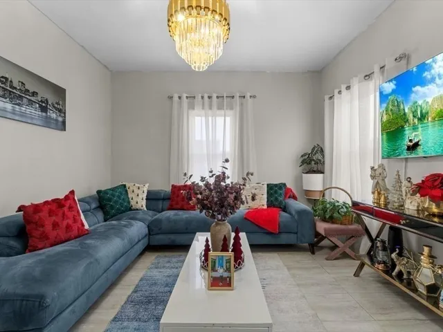 a living room with furniture toys and a large window