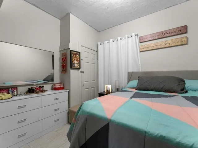 a bedroom with a bed and a closet