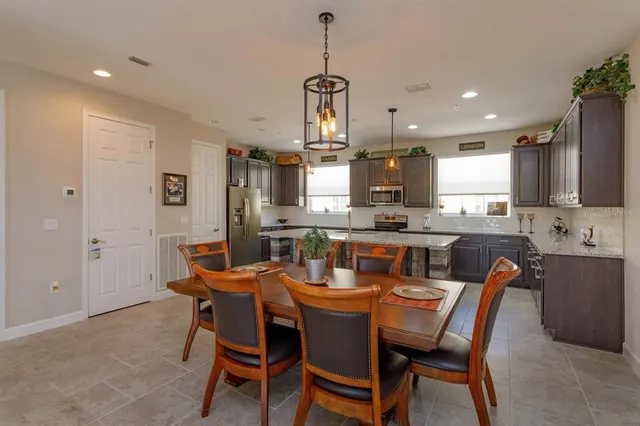 a dining room with granite countertop furniture and kitchen view