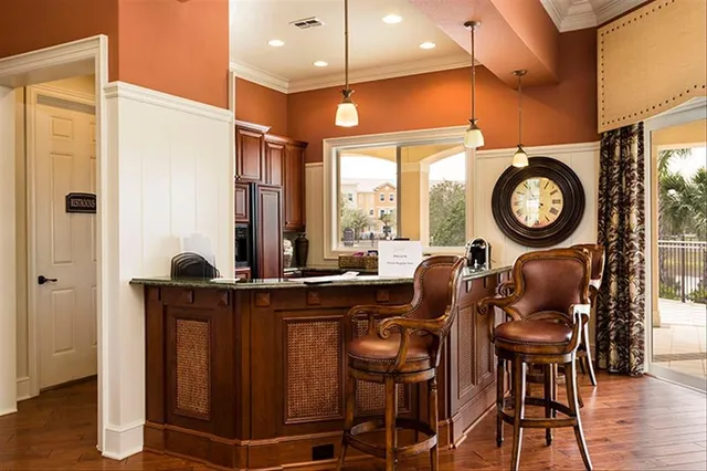 a view of a room with furniture and wooden floor