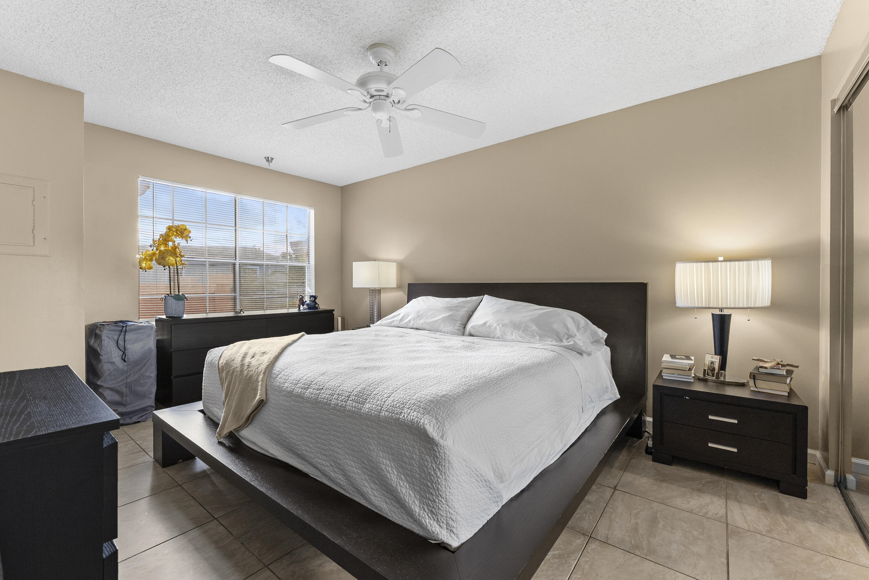 1365 Crystal Way, Unit H Delray Beach, FL 33444 - Photo 13 of 34 a bedroom with a bed and wooden floor