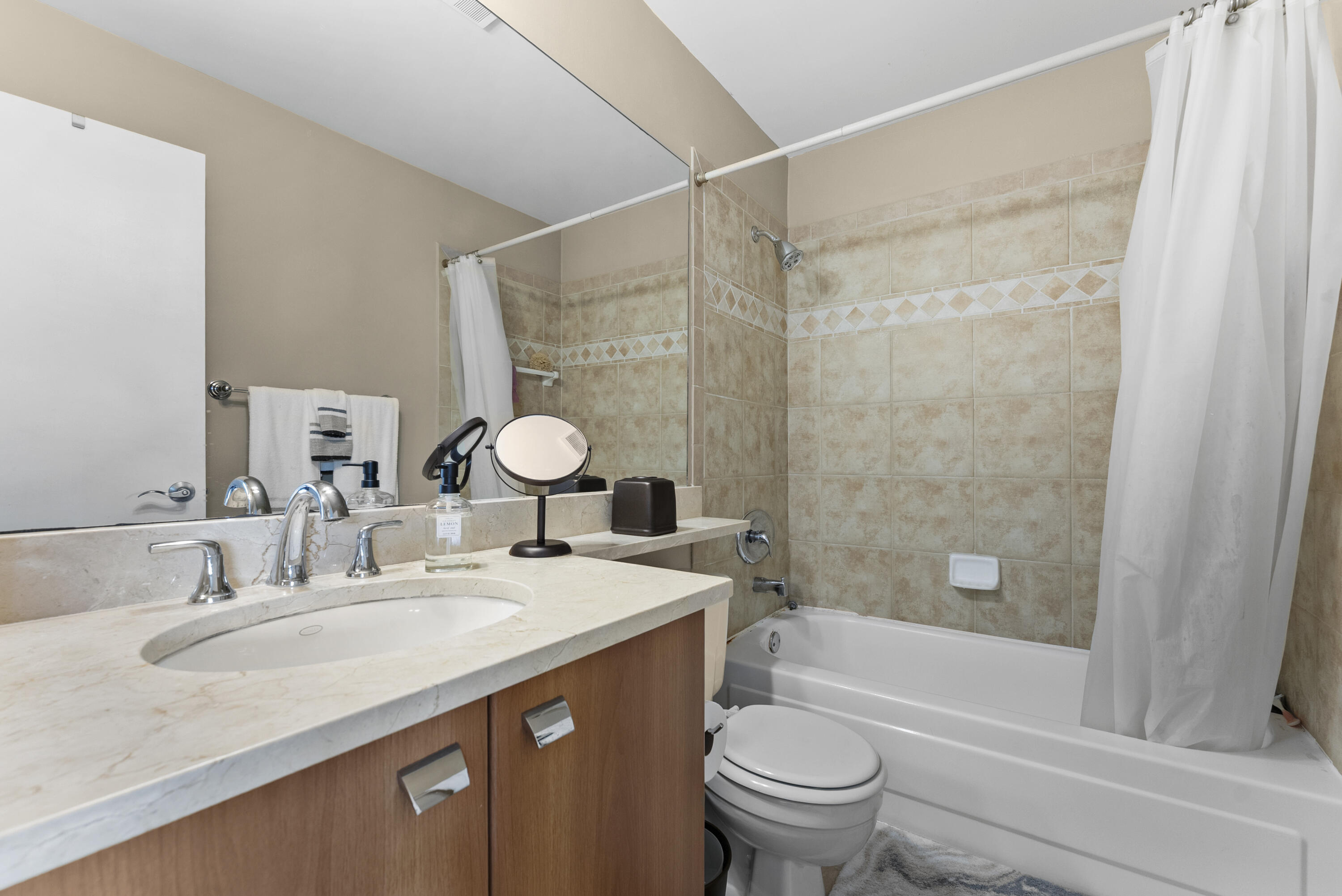 1365 Crystal Way, Unit H Delray Beach, FL 33444 - Photo 14 of 34 a bathroom with a granite countertop sink toilet and shower