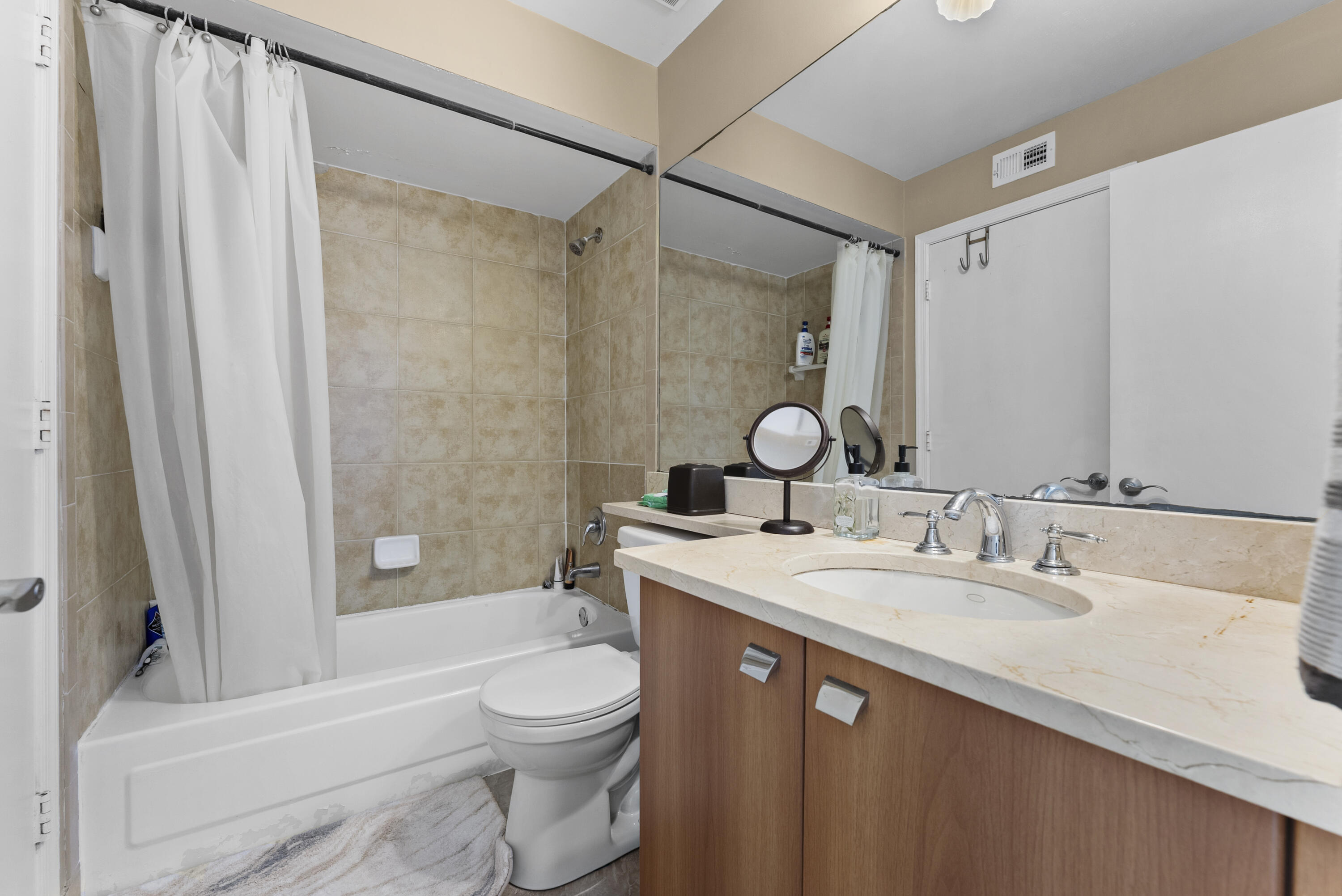 1365 Crystal Way, Unit H Delray Beach, FL 33444 - Photo 17 of 34 a bathroom with a sink a toilet and shower