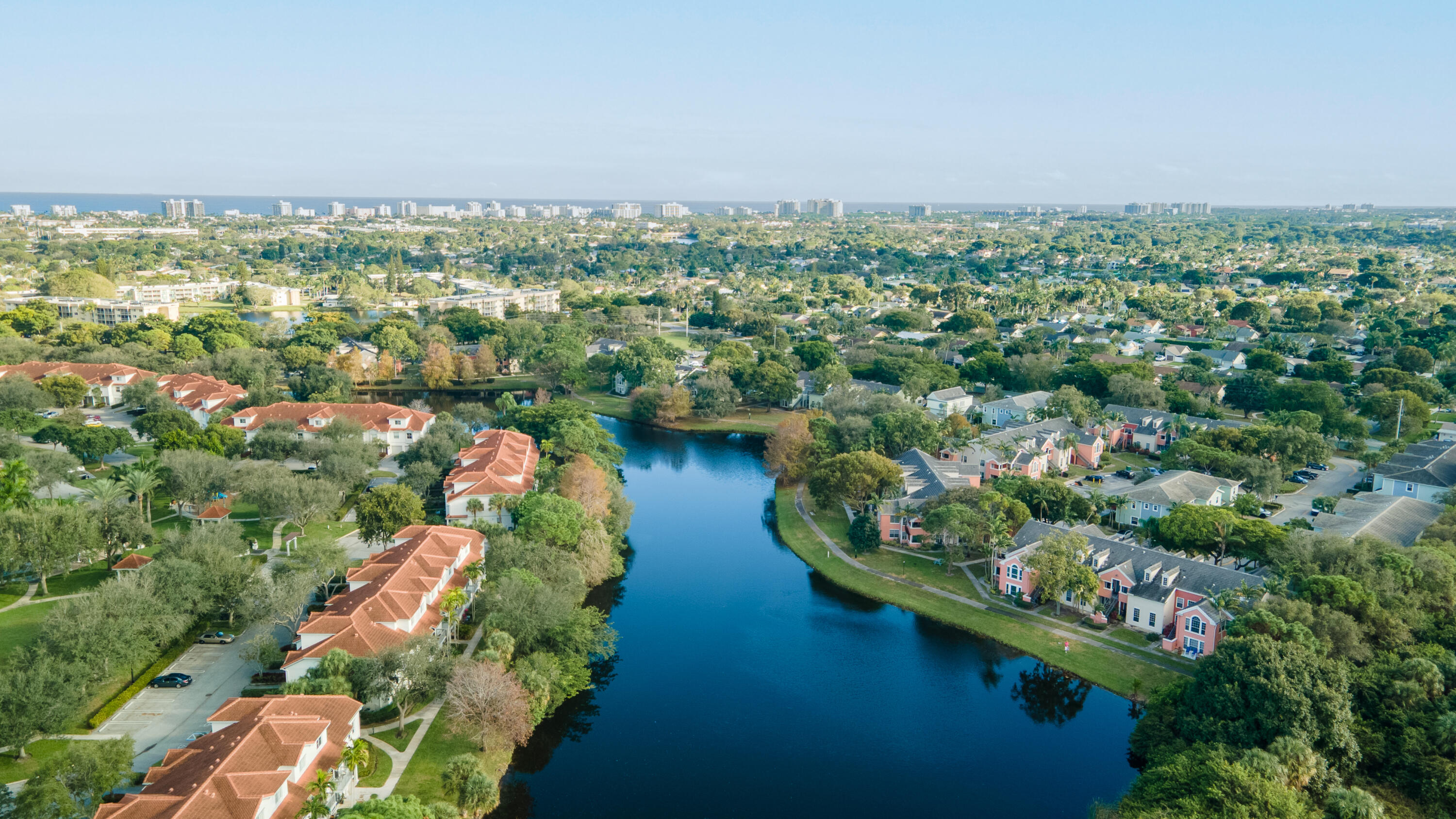 1365 Crystal Way, Unit H Delray Beach, FL 33444 - Photo 34 of 34 an aerial view of a city with lots of residential buildings and mountain view in back
