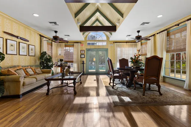 a living room with furniture dining table and a large window