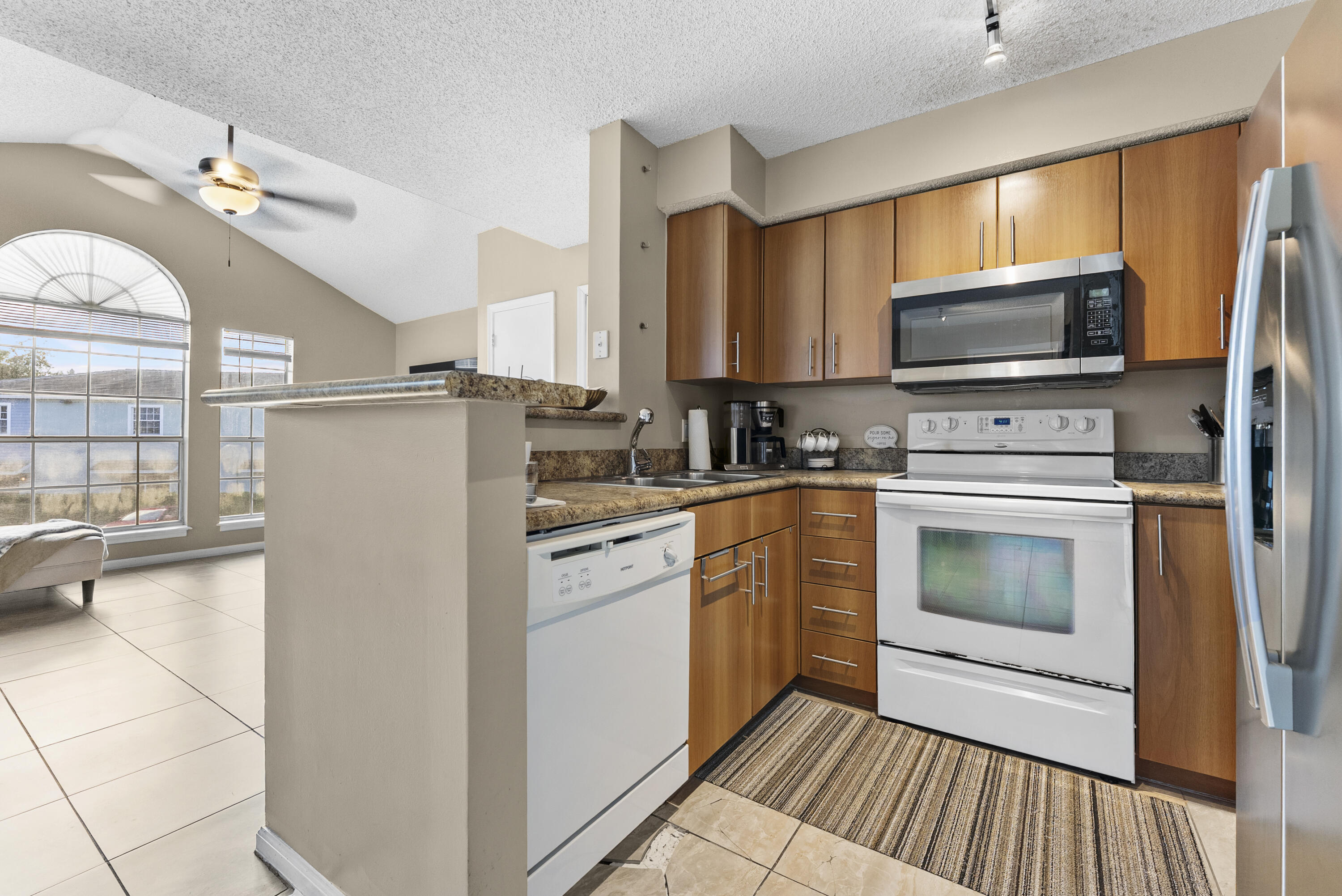 1365 Crystal Way, Unit H Delray Beach, FL 33444 - Photo 10 of 34 a kitchen with a refrigerator stove and microwave