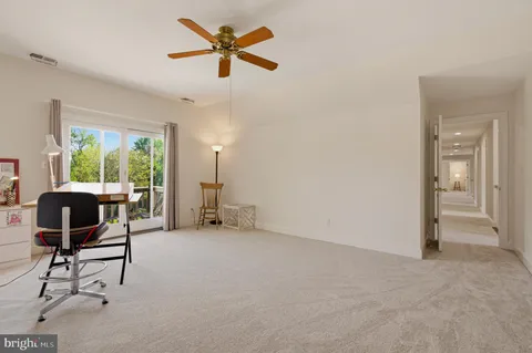 a view of a livingroom with workspace and a window