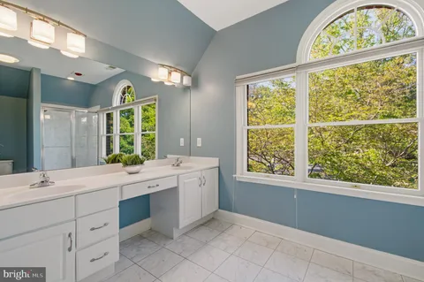 a view of bathroom with windows and dual sinks