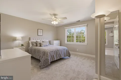 a spacious bedroom with a bed and a chandelier