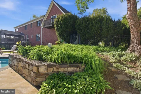 a wooden fence with some plants in the background