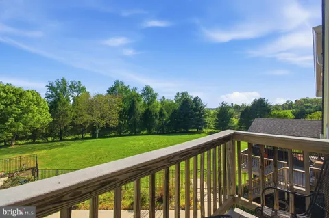 a view of a green field with sitting in background