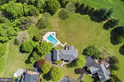 an aerial view of a house with a yard