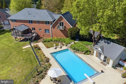 an aerial view of a house with swimming pool and glass doors