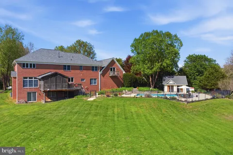 a front view of a house with a garden and trees