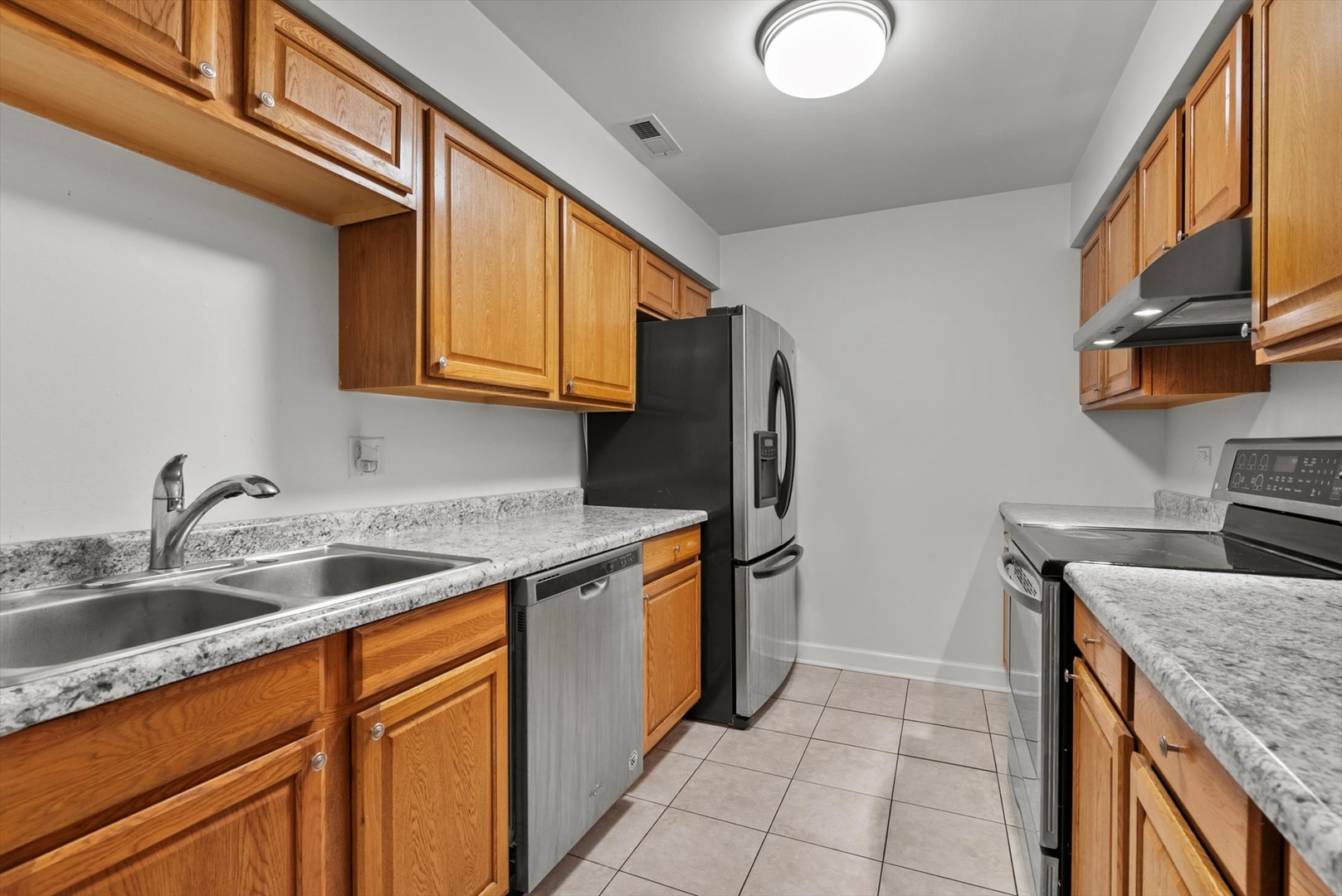 1426 Stonebridge Circle, Unit K8 Wheaton, IL 60189 - Photo 9 of 20 a kitchen with stainless steel appliances granite countertop a sink stove and refrigerator