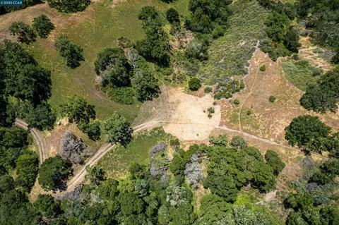 an aerial view of a houses with yard