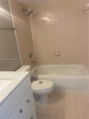 a bathroom with a granite countertop toilet a sink and bathtub