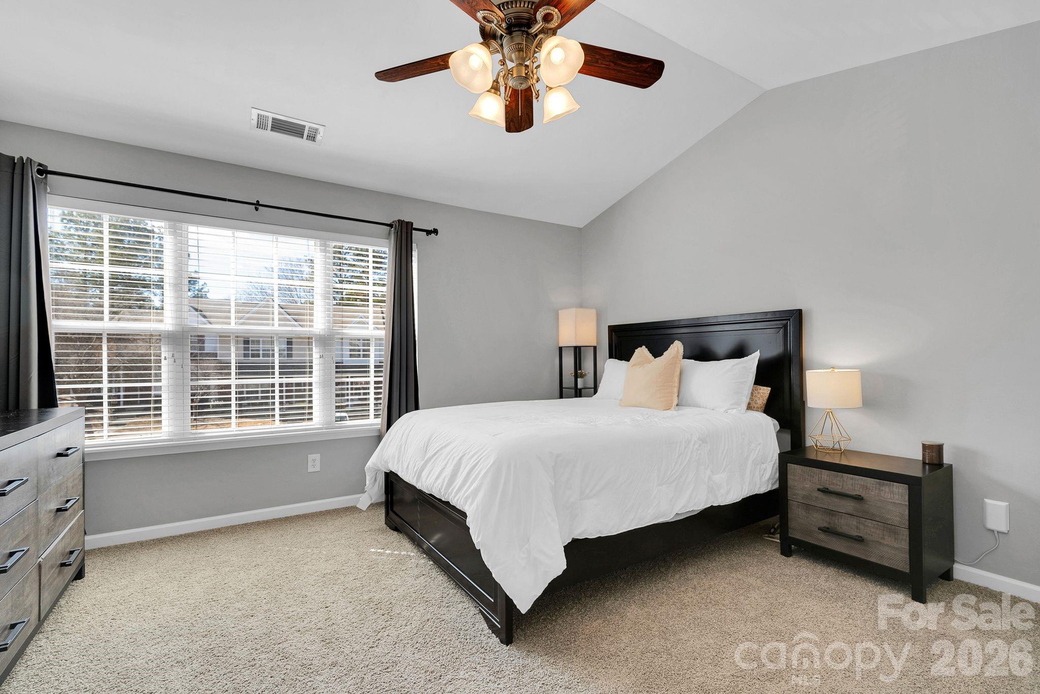 1570 Maypine Commons Way Rock Hill, SC 29732 - Photo 14 of 23 a bedroom with a bed and a chandelier