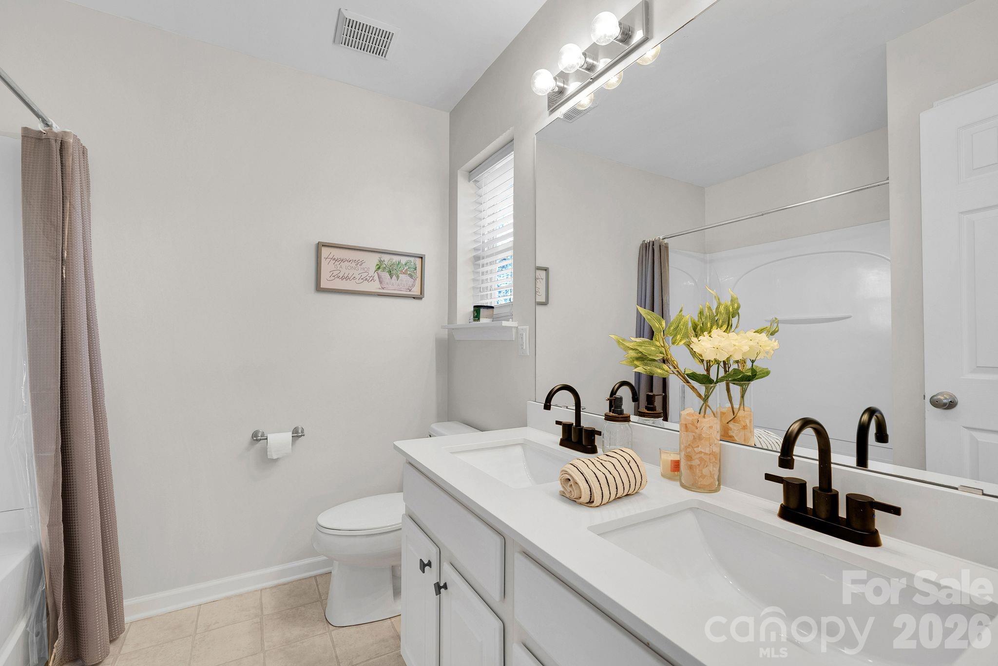 1570 Maypine Commons Way Rock Hill, SC 29732 - Photo 16 of 23 a bathroom with a toilet sink and mirror