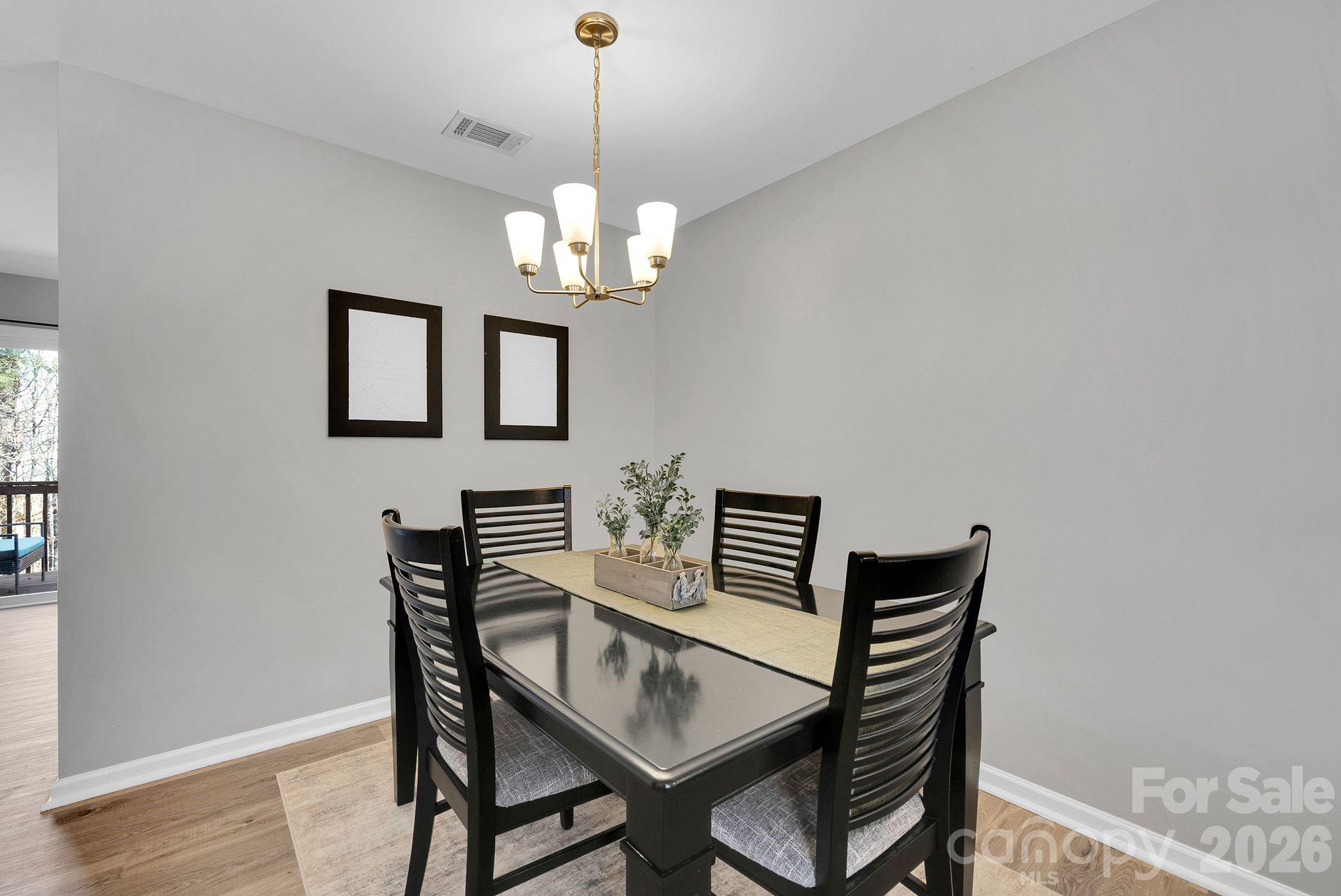 1570 Maypine Commons Way Rock Hill, SC 29732 - Photo 8 of 23 a view of a dining room with furniture and chandelier