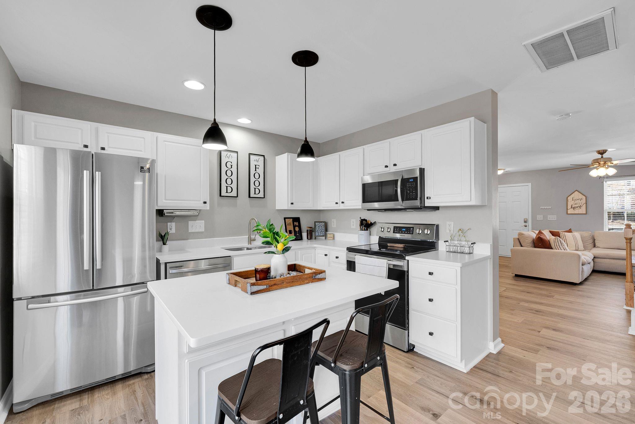 1570 Maypine Commons Way Rock Hill, SC 29732 - Photo 9 of 23 a kitchen with stainless steel appliances a stove a sink refrigerator and cabinets