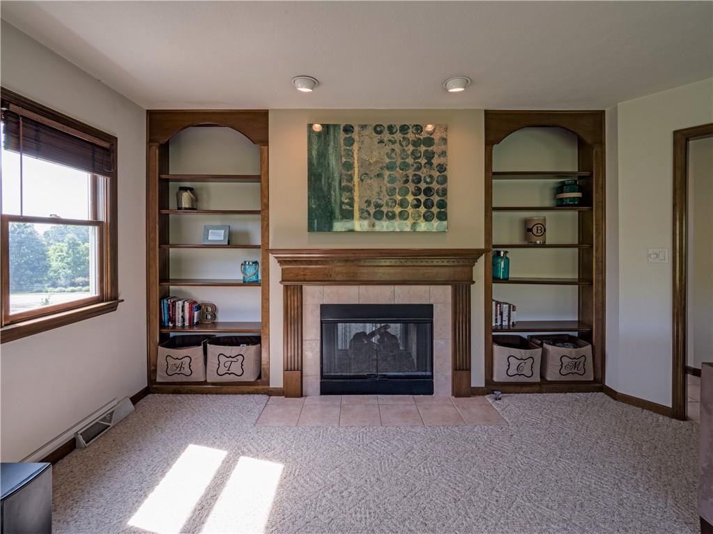 7003 Eagle Road Gibsonia, PA 15044 - Photo 11 of 25 Built-ins in the family room provide storage space and flank the gas fireplace.
