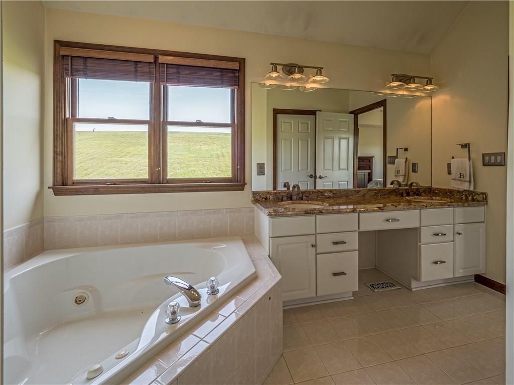 7003 Eagle Road Gibsonia, PA 15044 - Photo 15 of 25 The owner's bath includes modern lighting, granite counter tops, dual sinks, jet tub, and vaulted ceiling.
