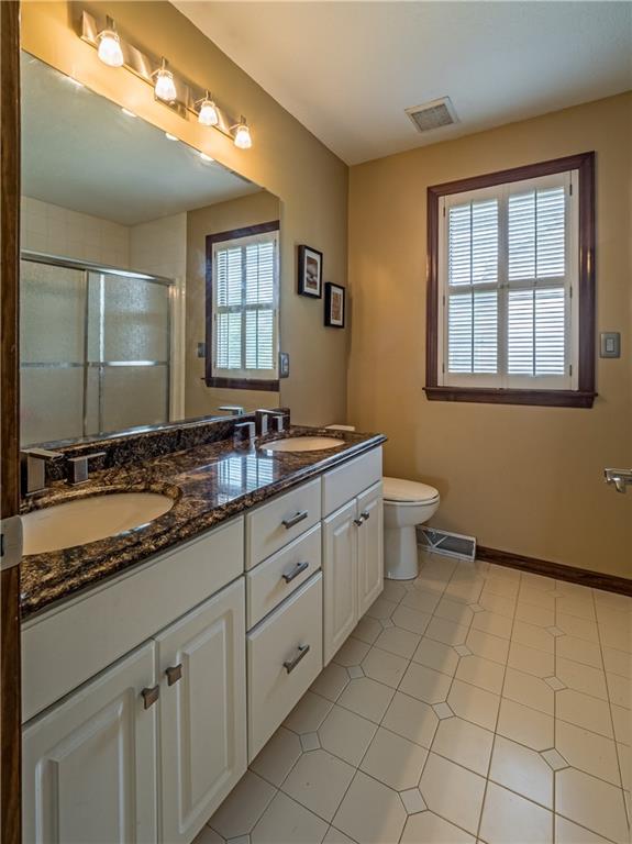 7003 Eagle Road Gibsonia, PA 15044 - Photo 18 of 25 The guest bedrooms share a hall bath featuring dual sinks, modern lighting, granite counter tops, and ample storage space.
