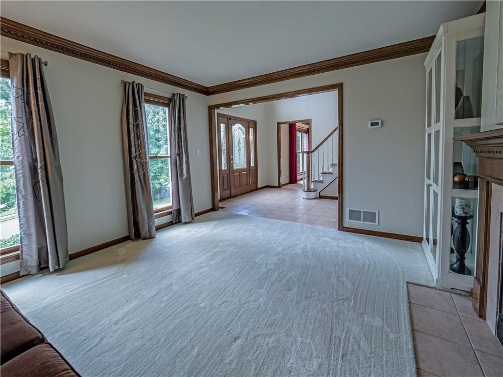 7003 Eagle Road Gibsonia, PA 15044 - Photo 5 of 25 The formal living room features crown molding and large windows allowing sunlight to flood the room.