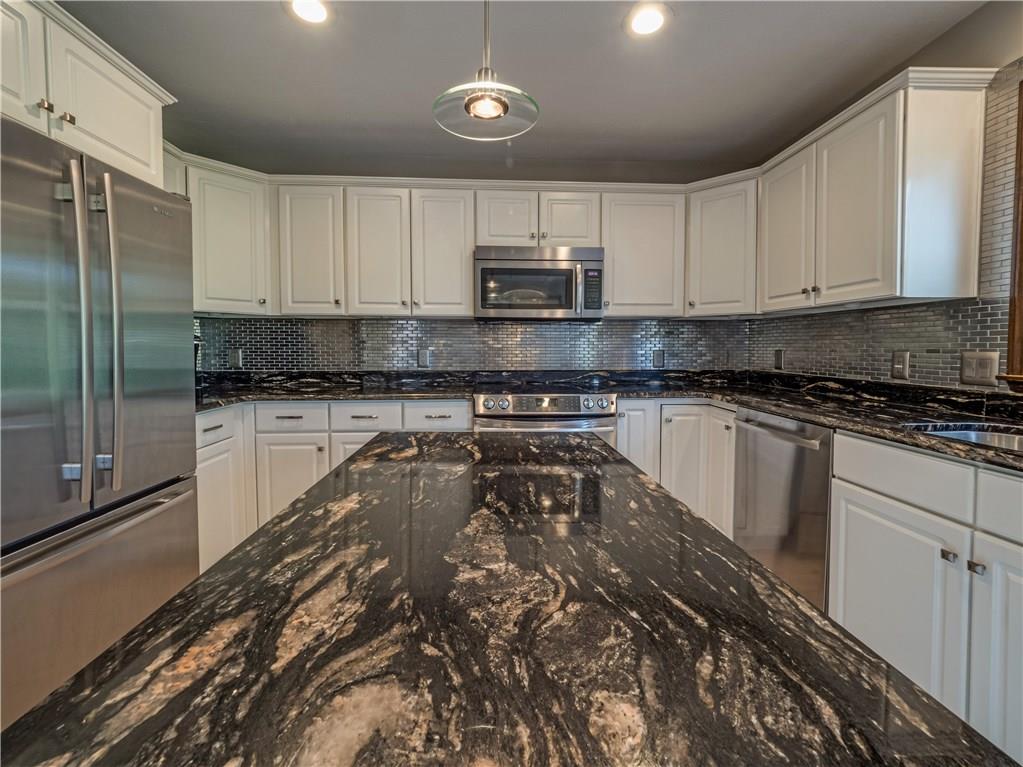 7003 Eagle Road Gibsonia, PA 15044 - Photo 8 of 25 A custom backsplash ties into the stainless appliances and modern dcor.