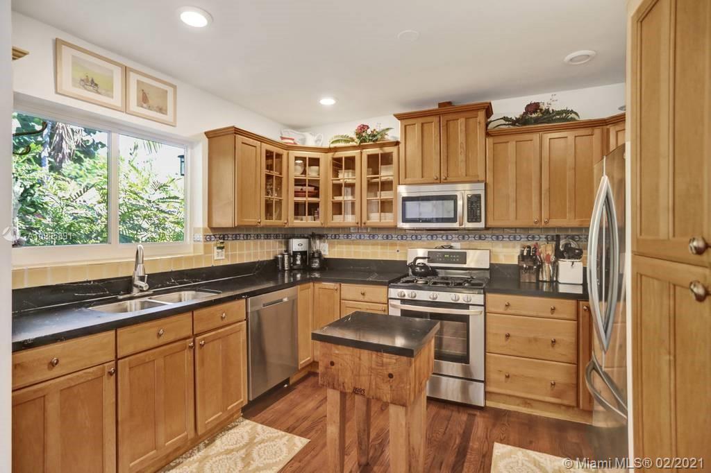 1301 South Biscayne Point Road Miami Beach, FL 33141 - Photo 11 of 45 a kitchen with granite countertop a stove sink and microwave