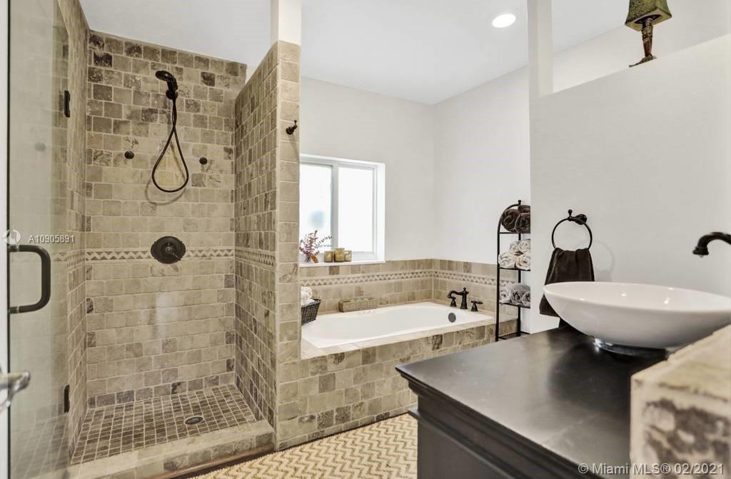 1301 South Biscayne Point Road Miami Beach, FL 33141 - Photo 16 of 45 a bathroom with a sink a toilet and shower