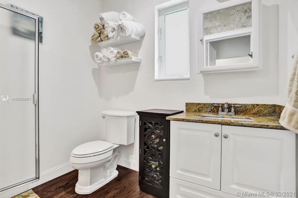 1301 South Biscayne Point Road Miami Beach, FL 33141 - Photo 20 of 45 a kitchen with a sink a toilet and cabinets