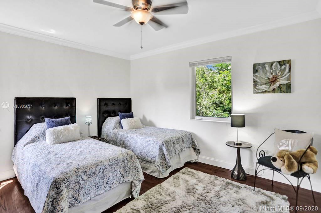 1301 South Biscayne Point Road Miami Beach, FL 33141 - Photo 22 of 45 a bedroom with two beds and a flat screen tv