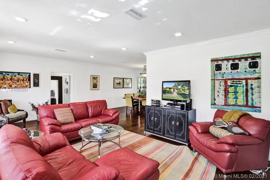 1301 South Biscayne Point Road Miami Beach, FL 33141 - Photo 5 of 45 a living room with furniture and a flat screen tv