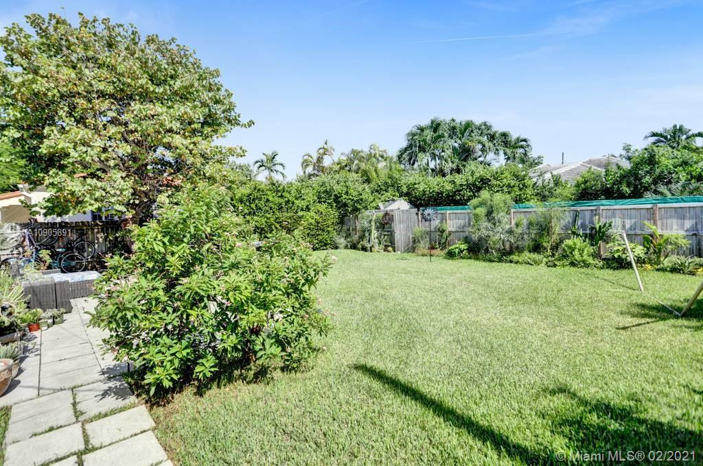 1301 South Biscayne Point Road Miami Beach, FL 33141 - Photo 44 of 45 a view of a garden with a bench in a garden