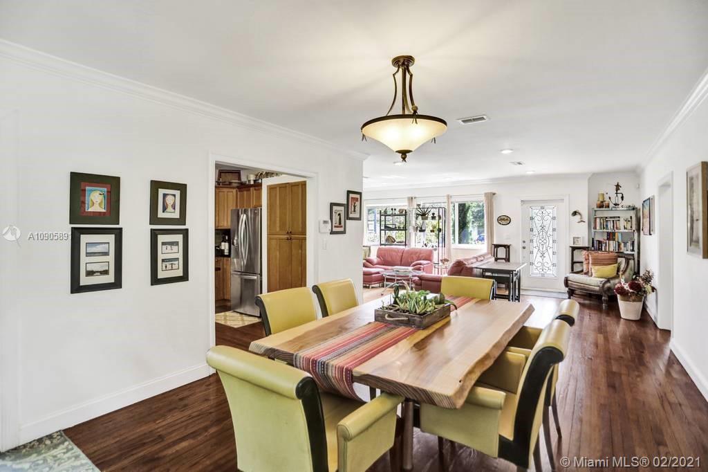 1301 South Biscayne Point Road Miami Beach, FL 33141 - Photo 7 of 45 a view of a dining room with furniture wooden floor and chandelier