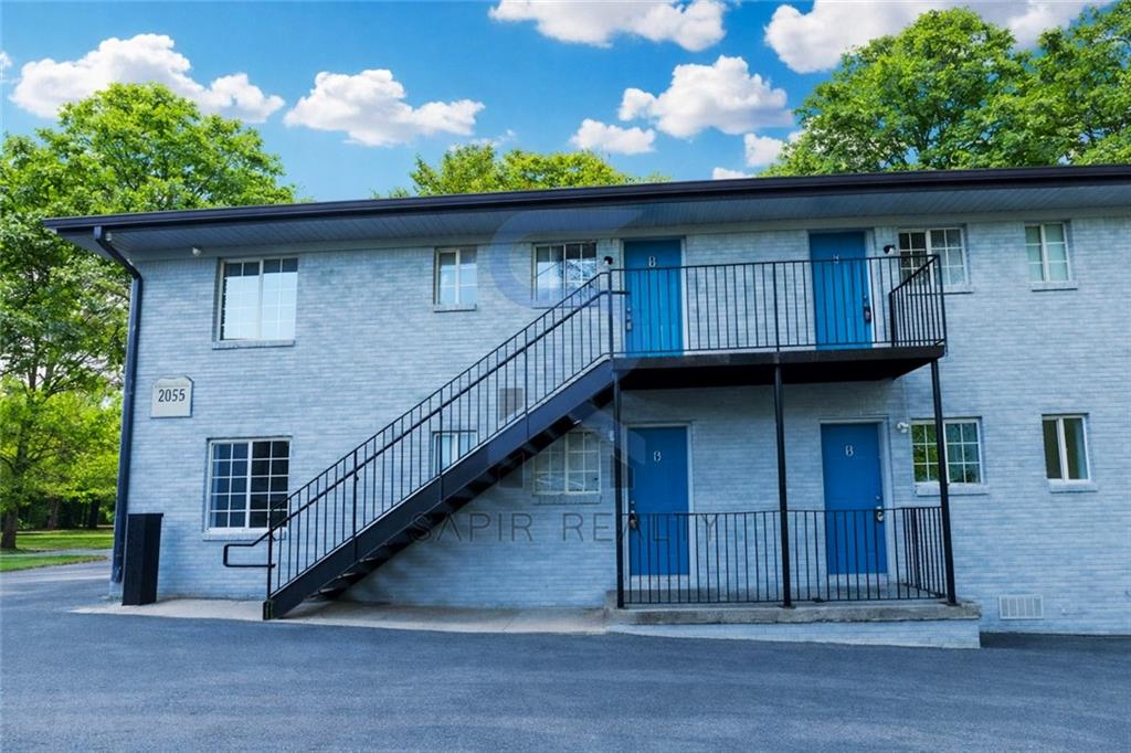 2055 Alison Court Southwest, Unit 3 Atlanta, GA 30311 - Photo 2 of 12 a front view of a house with a wooden fence