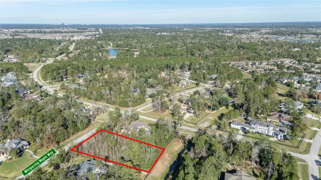 an aerial view of residential houses with outdoor space and trees