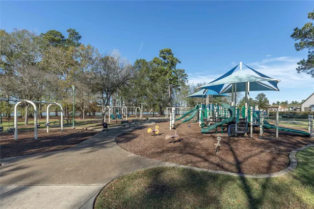 a view of a park with swings and a yard